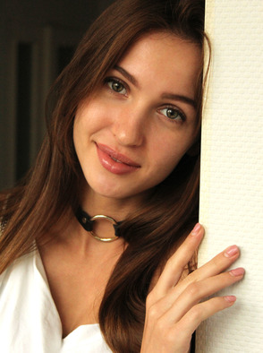 Holly Haim Wearing Nothing But A Leather Choker And A Playful Smile