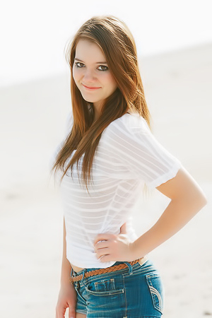 Emily French in jean shorts in sand