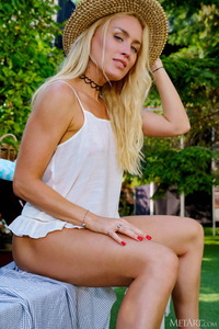 Liza B Wavy Blonde Hair Cascades Over Her Shoulders