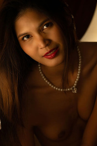 Tan Asian Cutie Smiles Flirtatiously As Her Outfit Slips From Her Shoulders