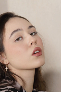 Emily Eliot Sliding A Hand Down To Stroke Her Shaved Pussy Sensuously