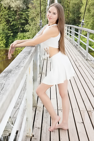 Sasha Quinn Smiling Playfully As Her Short Skirt Flips Up To Reveal She’s Not Wearing Panties